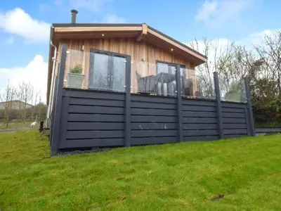 a small house on top of a grass field at Crook Lodge in Cartmel