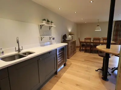 a kitchen with a sink and a counter top at Yew Cottage in Backbarrow