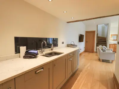 a kitchen with a sink and a counter top at Lime Cottage in Backbarrow