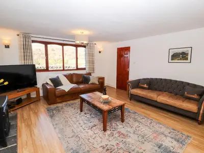 a living room with a couch and a coffee table at Green Hills Farm in Greenodd