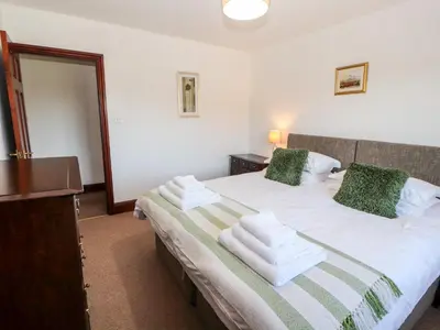a bedroom with a bed with towels on it at Green Hills Farm in Greenodd