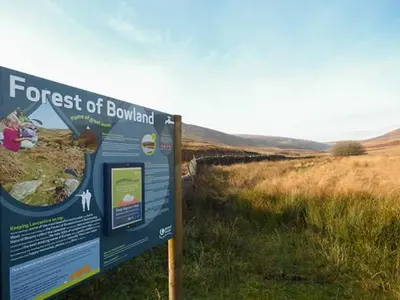 a sign in the middle of a field at Park Brook Retreat in Scorton