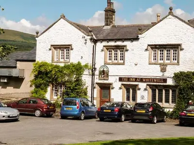 a group of cars parked in front of a building at Park Brook Retreat in Scorton