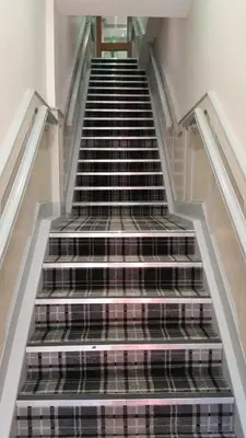 a stair case with black and white shoes on it at Central Station Hotel Liverpool in Liverpool