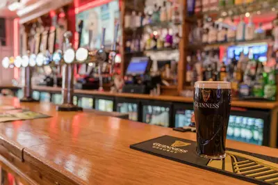 a glass of beer sitting on top of a bar at Central Station Hotel Liverpool in Liverpool
