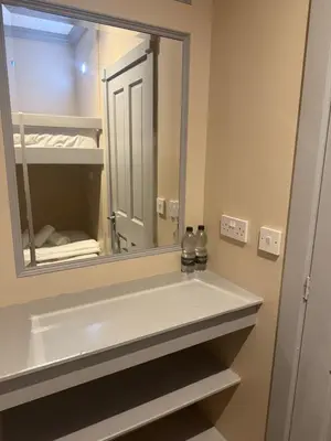 a bathroom with a sink and a mirror at Central Station Hotel Liverpool in Liverpool