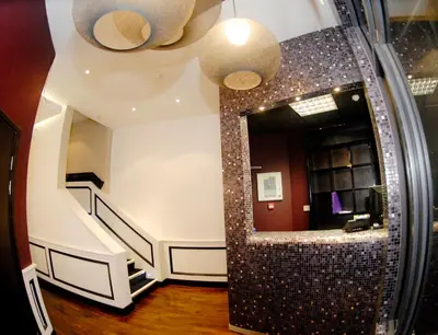 a bathroom with a staircase and a mirror at Print Works Hotel in Liverpool