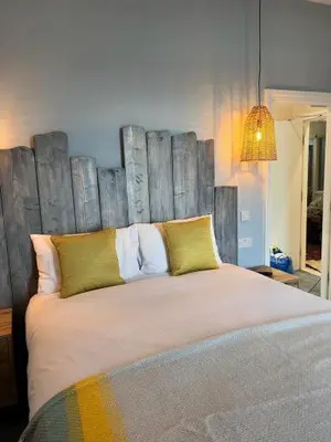 a bedroom with a large bed with a wooden headboard at Craig-y-Don in Blackpool