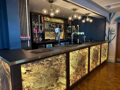 a bar with a marble counter in a room at Craig-y-Don in Blackpool