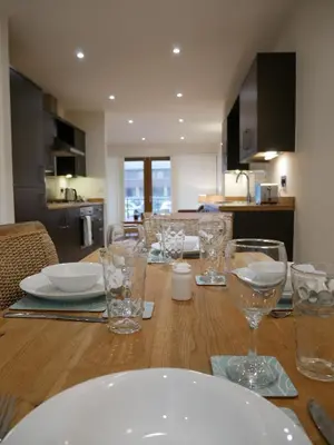 a wooden table with glasses and plates on it at 8 Swan House in Carnforth