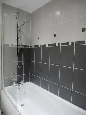 a bathroom with a shower and a bath tub at 8 Swan House in Carnforth