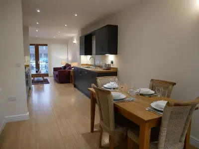 a kitchen and dining room with a table and chairs at 8 Swan House in Carnforth