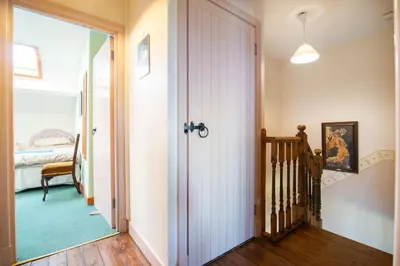 a hallway with a door leading to a bedroom at Midsummer Barn in Darwen