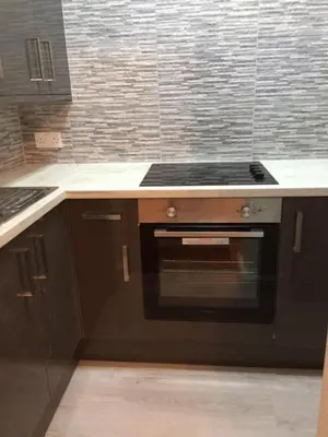 a kitchen with a black stove top oven at Woodlands Holiday Apartments in Lytham St Annes