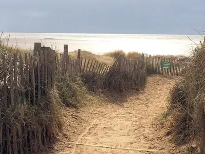 a fence on the side of a dirt road at Woodlands Holiday Apartments in Lytham St Annes
