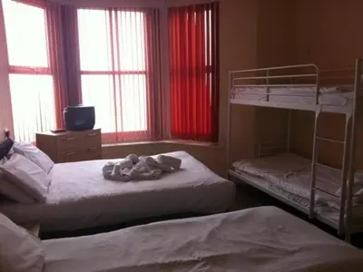 two bunk beds in a room with windows at The Royal Windsor Hotel in Blackpool