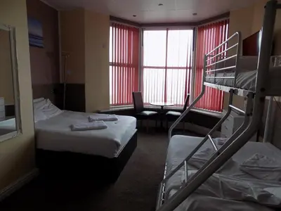 a hotel room with two bunk beds and a desk at The Royal Windsor Hotel in Blackpool
