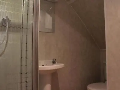 a bathroom with a sink and a shower and a toilet at The Royal Windsor Hotel in Blackpool