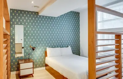 a bedroom with a bed and a green wall at Terlon Apartments in Liverpool