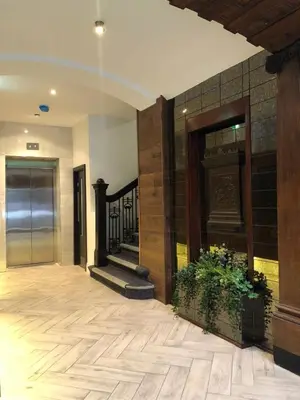 an empty lobby with a staircase and a door at Terlon Apartments in Liverpool