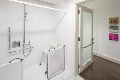 a white bathroom with a shower and a glass door at Hotel Indigo Liverpool by IHG in Liverpool