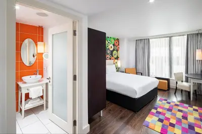 a hotel room with a bed and a bathroom at Hotel Indigo Liverpool by IHG in Liverpool