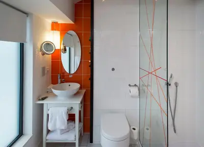 a bathroom with a toilet and a sink and a shower at Hotel Indigo Liverpool by IHG in Liverpool