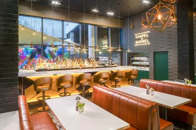 a restaurant with tables and chairs and a bar at Hotel Indigo Liverpool by IHG in Liverpool