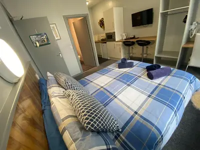 a bedroom with a bed with two pillows on it at Seaside Suites Superior Family Apartments in Blackpool