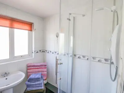 a bathroom with a shower and a sink at Beech Cottage in Ulverston