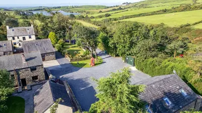 an aerial view of an old house in the countryside at Woodside Barn in Ulverston