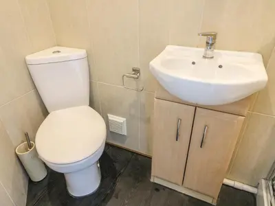 a bathroom with a white toilet and a sink at Riverside View in Grange Over Sands