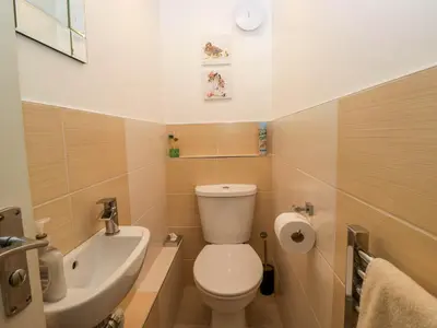 a small bathroom with a toilet and a sink at The Old Mill in Grange Over Sands