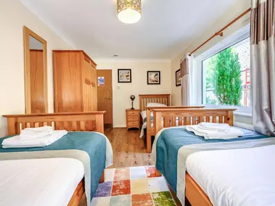a room with two beds and a window at Eden House in Ulverston