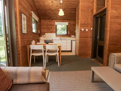a kitchen and living room with a table and chairs at Buttermere in Ulverston