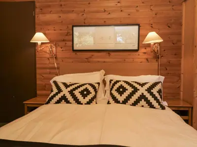a bedroom with a bed with two lights and two pillows at Buttermere in Ulverston