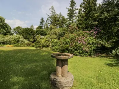 a bird bath sitting in the middle of a lawn at Grasmere in Ulverston