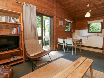 a living room with a television and a table at Grasmere in Ulverston