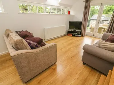 a living room with two couches and a television at The Potting Shed in Carnforth