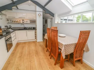 a kitchen and dining room with a table and chairs at The Potting Shed in Carnforth