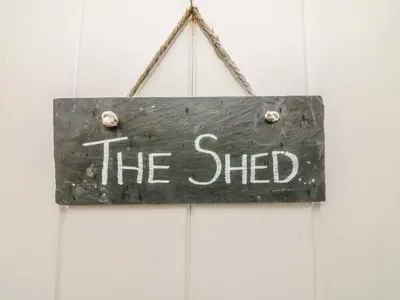 a sign that reads the shed hanging on a wall at The Potting Shed in Carnforth