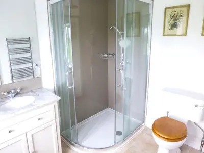 a bathroom with a shower with a toilet and a sink at The Old Forge in Waddington