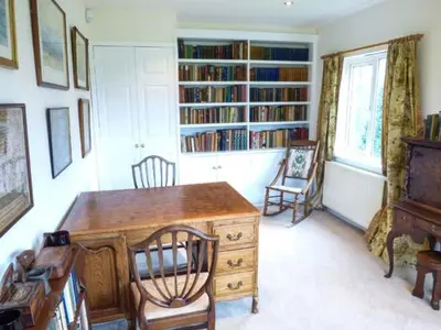 a room with a desk and chairs and bookshelves at The Old Forge in Waddington