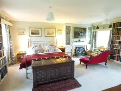 a bedroom with a bed and a couch and a fireplace at The Old Forge in Waddington