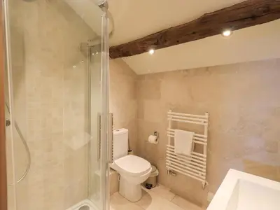 a bathroom with a toilet and a shower at Keepers Cottage in Ulverston