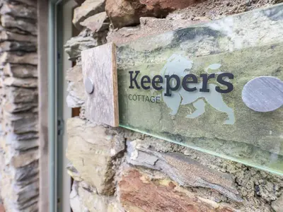 a keepers sign on the side of a building at Keepers Cottage in Ulverston