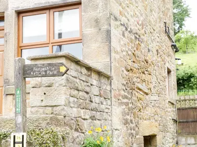 a street sign in front of a stone building at The Old Post Office in Garstang