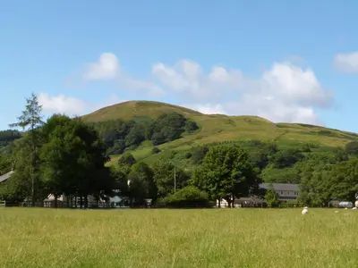 a field with a hill in the background at The Old Post Office in Garstang