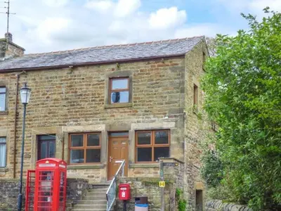 a brick building with a red telephone booth in front of it at The Old Post Office in Garstang