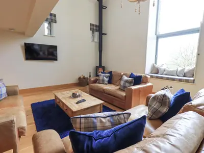 a living room with couches and a coffee table at Oak Cottage in Ulverston